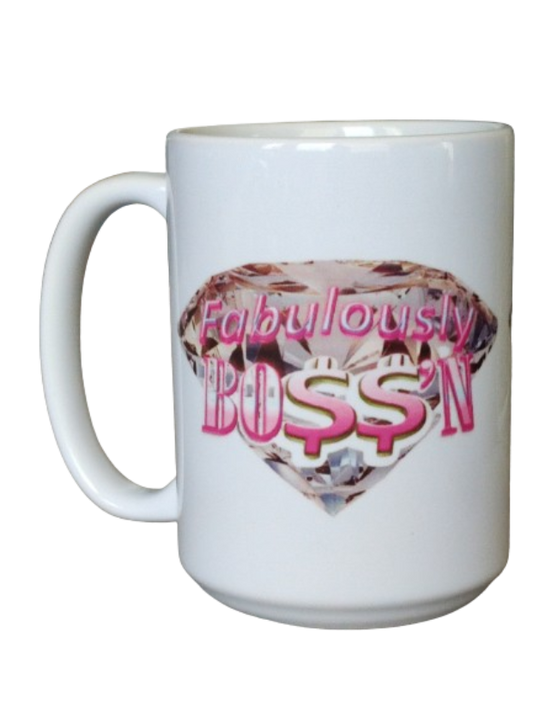 A white 15oz fabulous boss mug displaying a large, brilliant pink diamond design coffee mug. Overlaid on the diamond is the phrase "Fabulously BOSS'N" in vibrant pink, using dollar signs for the 'S's. This boss lady mug is an ideal entrepreneur mug for her and a stylish money sign mug for her.

www.justsaynpromos.com