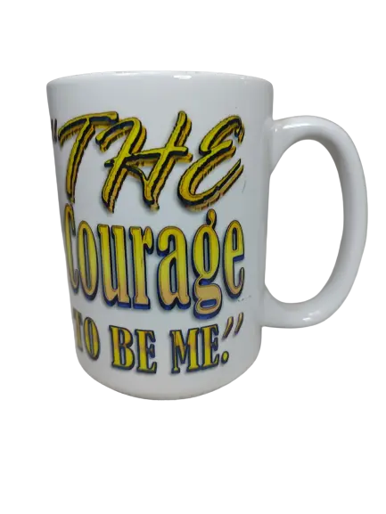 A white 15oz courage mug for him, displaying the full phrase "THE COURAGE TO BE ME" in prominent gold and blue outlined text. The lettering has a shimmering effect, making this an inspiring motivational mug for men and a great inspirational coffee mug.

www.justsaynpromos.com