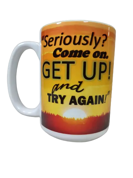 A white 15oz motivational quote coffee mug featuring an orange and yellow sunset background with a dark silhouette of mountains or trees at the base. Bold black and orange text reads, "Seriously? Come on. GET UP! and TRY AGAIN!". This funny motivational mug is a perfect encouragement coffee mug and a thoughtful gift for someone struggling.
www.justsaynpromos.com